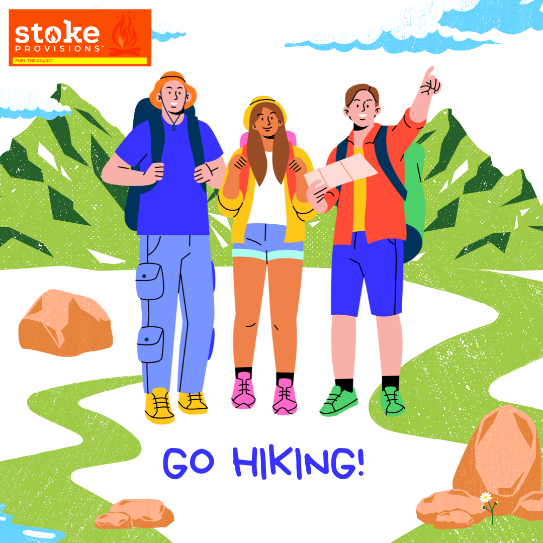 A diverse group of young adults hiking in a lush national park, enjoying grass-fed beef snack sticks against a backdrop of mountains and a clear blue sky.